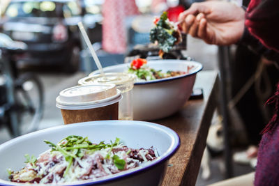 Cropped hand of person having food at table