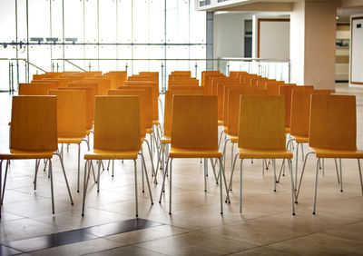 Empty chairs and tables in room