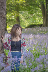 Woman standing by flowering tree