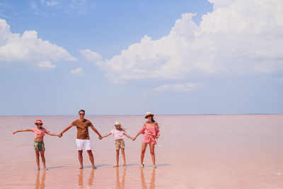 People on beach against sky