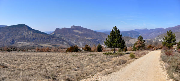 Scenic view of mountains against clear blue sky