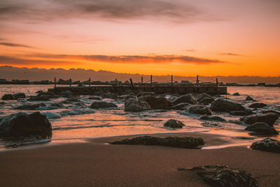 Scenic view of beach against sky during sunset