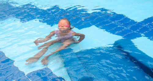 Young woman swimming in pool