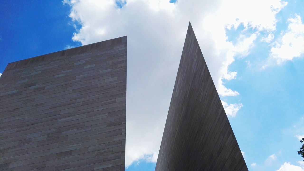 low angle view, architecture, built structure, building exterior, sky, blue, tall - high, cloud - sky, cloud, tower, modern, day, sunlight, outdoors, city, no people, building, office building, skyscraper, tall