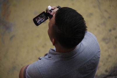 Rear view of man photographing