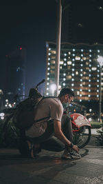 Rear view of people on street at night