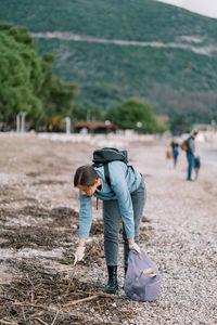 Rear view of man walking on field