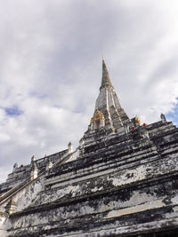 Low angle view of temple building against cloudy sky