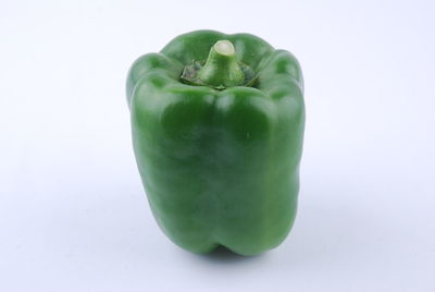 Close-up of green fruit against white background