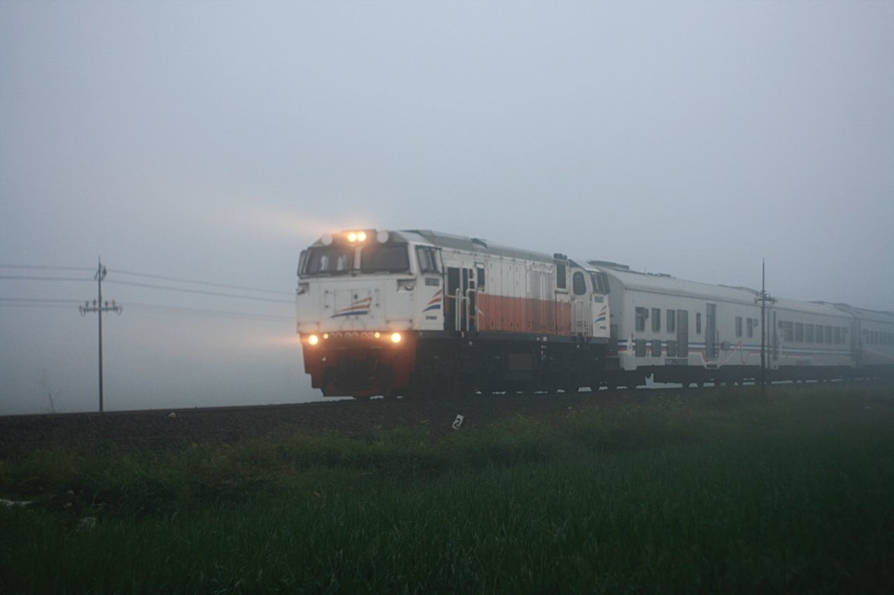 TRAIN ON RAILROAD TRACKS AGAINST SKY