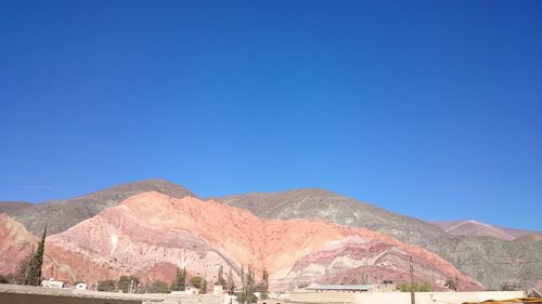 Scenic view of mountains against clear blue sky