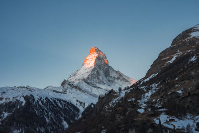 Scenic view of snowcapped mountains against clear sky