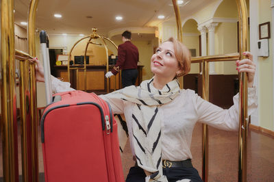 Portrait of young woman standing in train