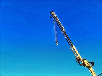 Low angle view of crane against clear sky