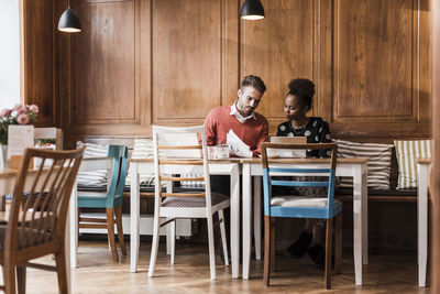 Young man and woman having a meeting in a cafe