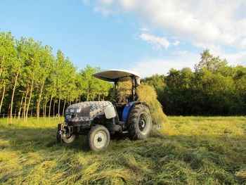 Tractor on field against sky