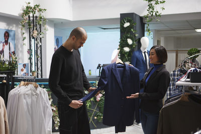 Rear view of people in traditional clothing store