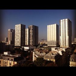 View of modern buildings against blue sky