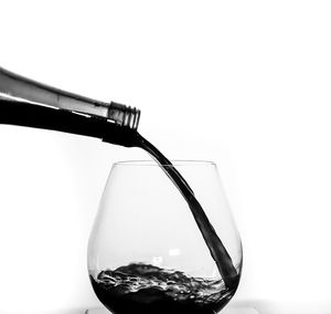 Close-up of beer glass bottle against white background