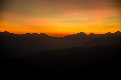 Scenic view of silhouette mountains against sky during sunset