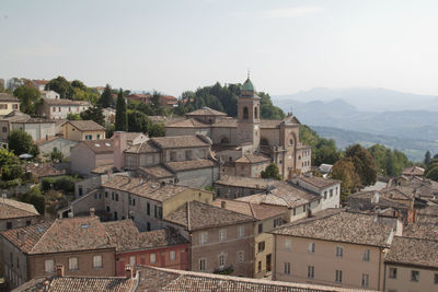 High angle view of buildings in town against clear sky