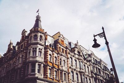 Low angle view of building against cloudy sky