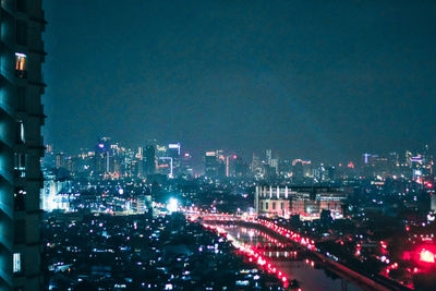 Aerial view of city lit up at night