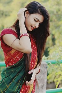 Young woman in sari standing outdoors