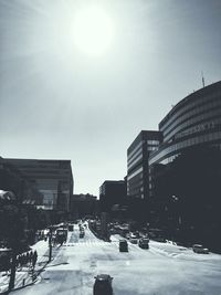 Cars on road in city against clear sky