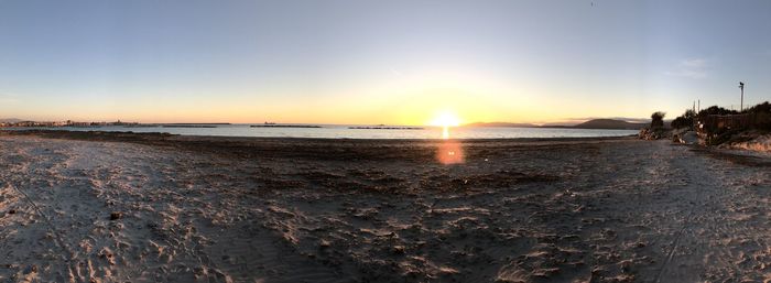 Scenic view of beach against sky during sunset