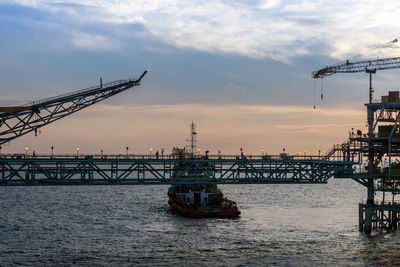 View of bridge over river against cloudy sky