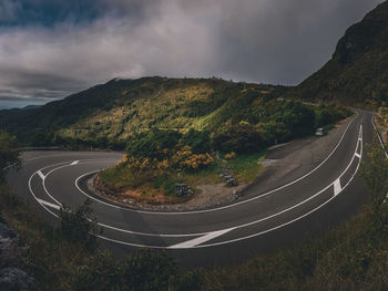 Aerial view of road by mountain against sky