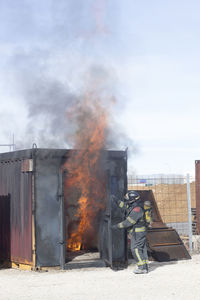 Firefighter extinguishing burning building