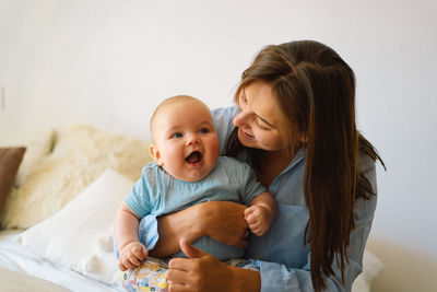 Portrait of a happy mother and child. a young mother is play with little baby boy