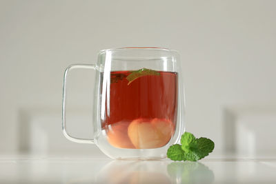 Close-up of drink in glass against white background