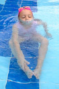 Portrait of woman swimming in pool