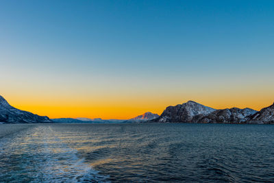 Scenic view of sea against clear sky during sunset