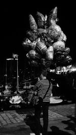 Rear view of man standing at night