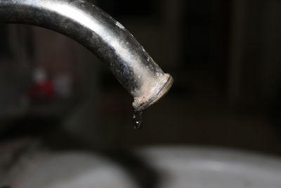 Close-up of water drop from faucet