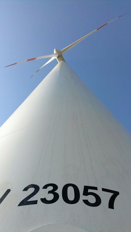 low angle view, clear sky, communication, alternative energy, wind power, windmill, environmental conservation, wind turbine, renewable energy, transportation, fuel and power generation, text, arrow symbol, day, outdoors, flag, no people, guidance, copy space, blue