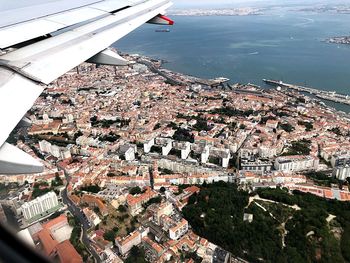 High angle view of townscape and sea seen from airplane