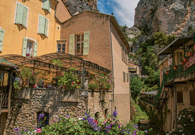 Restaurant with flowers and cliffs at the village of moustiers-sainte-marie, in the french provence.