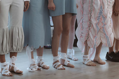 Cropped figures of models in trendy designer outfits on the backstage. fashion shot