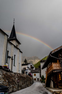 View of rainbow over buildings in city