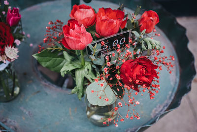 High angle view of small red roses bouquet with a price tag