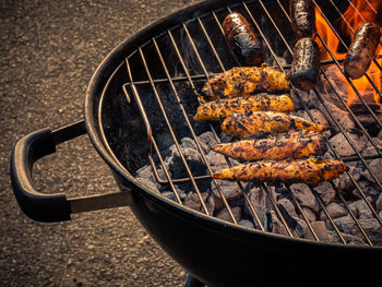 High angle view of meat on barbecue grill