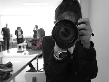 Portrait of woman photographing