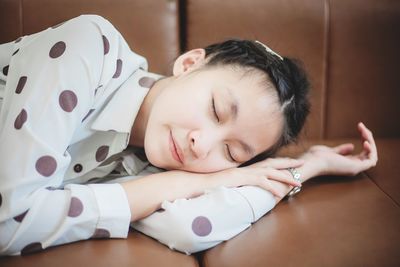 Portrait of cute baby sleeping on bed at home