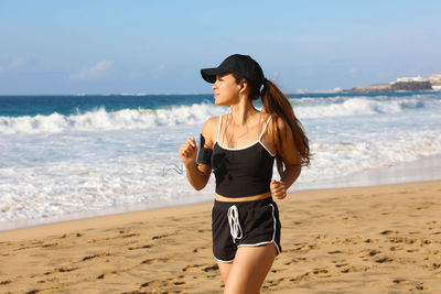 Young woman jogging at beach