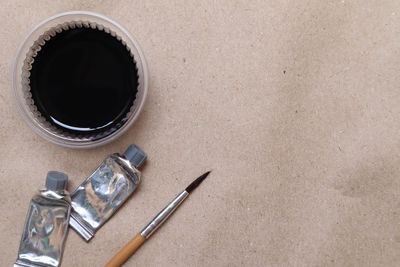 High angle view of cigarette in pen on table